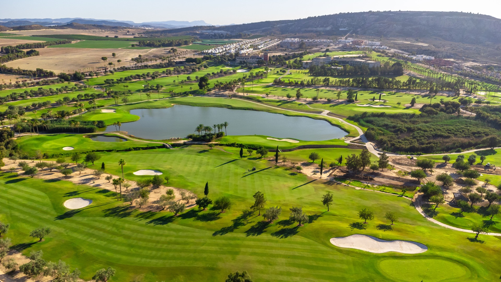 Wide aerial view of a luxury green golf course